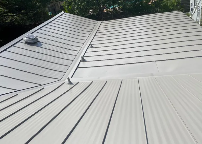 Solar attic fan installed on a metal roof for Roof Ventilation in West New York